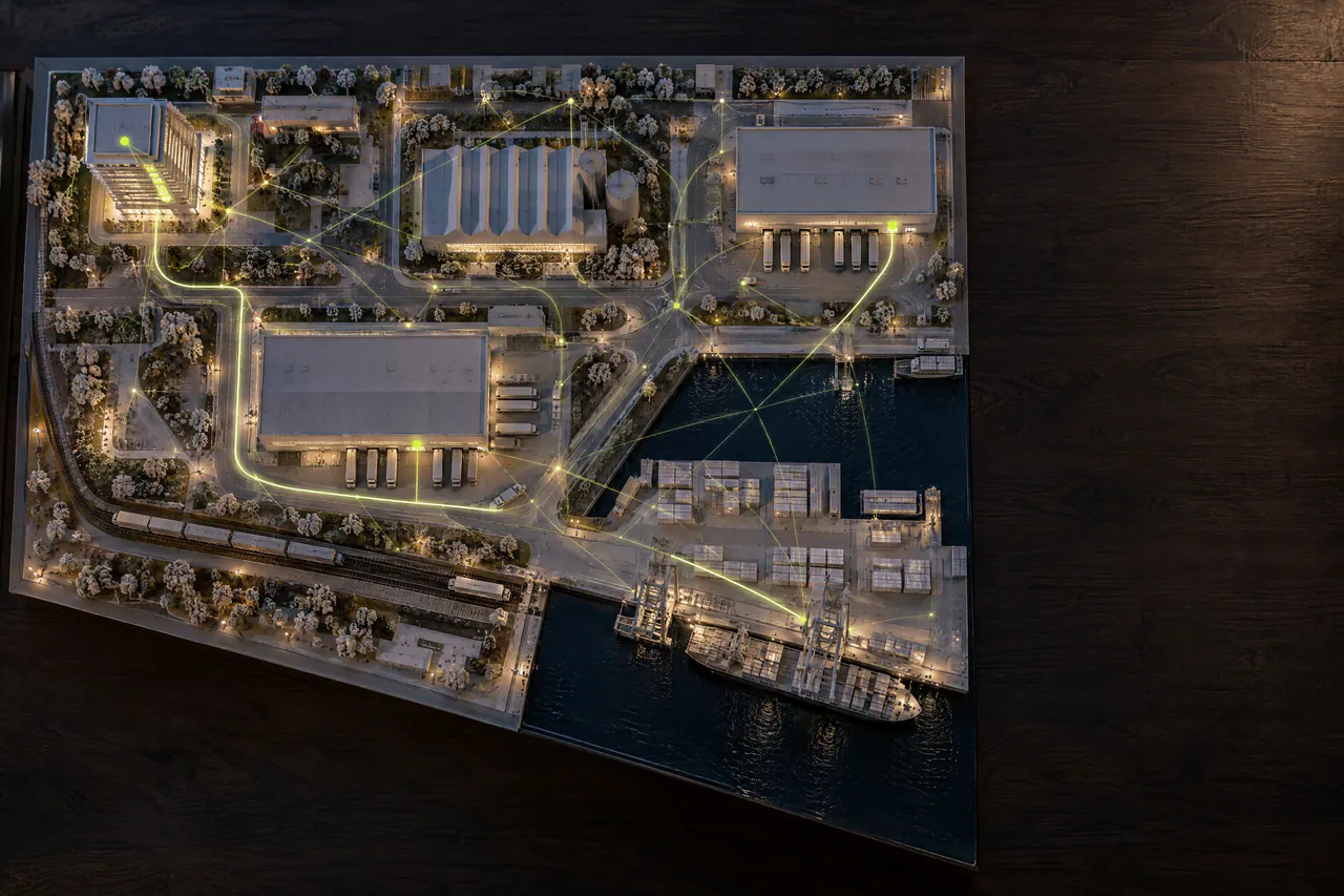 A maquete vista de cima, com os prédios ligados por muitos fios finos verde-limão.